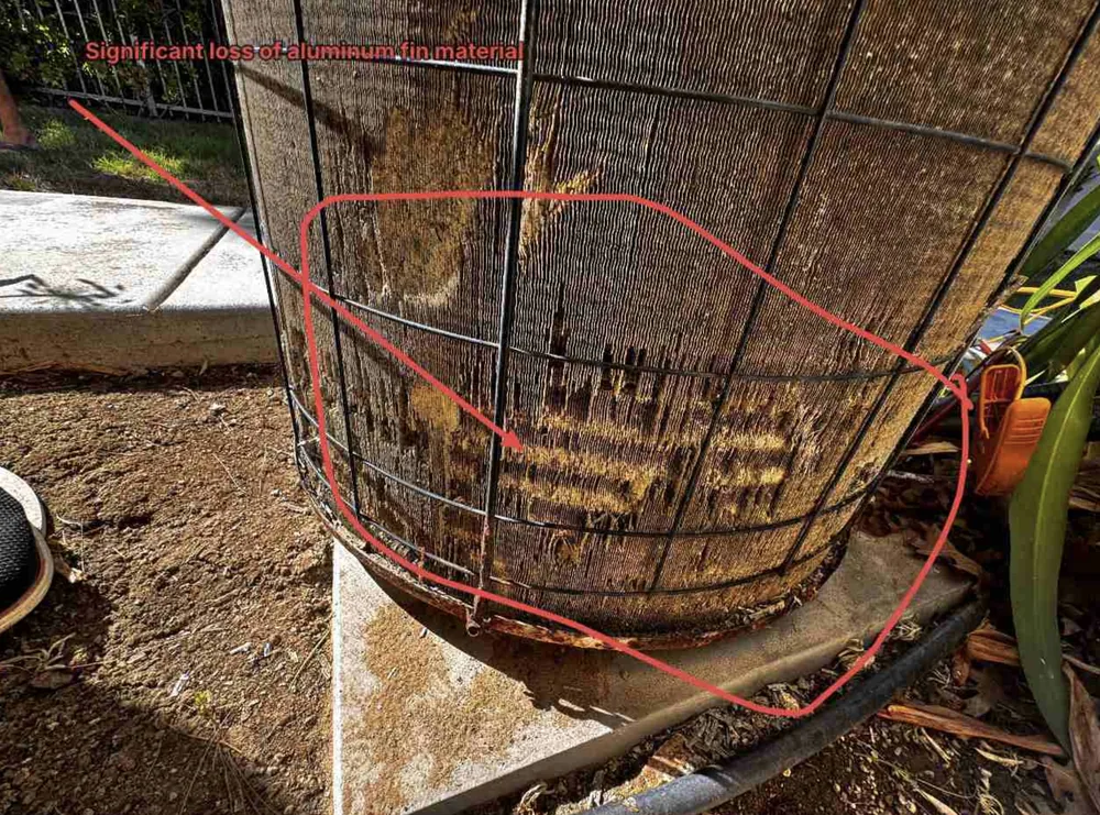 Condenser coil photo annotated with an arrow, circle and label reading significant loss of aluminum fin material
